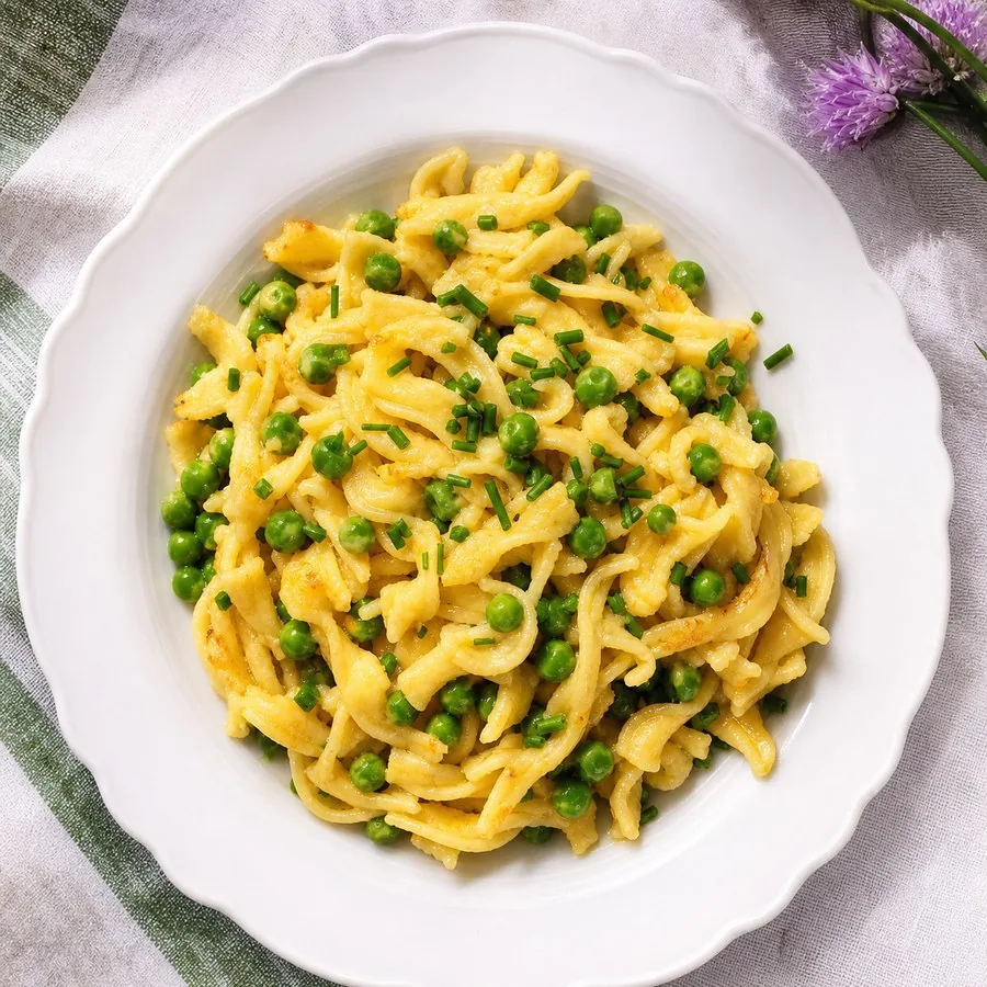 Austrian Eiernockerl with Peas and Chives, plated and ready to serve