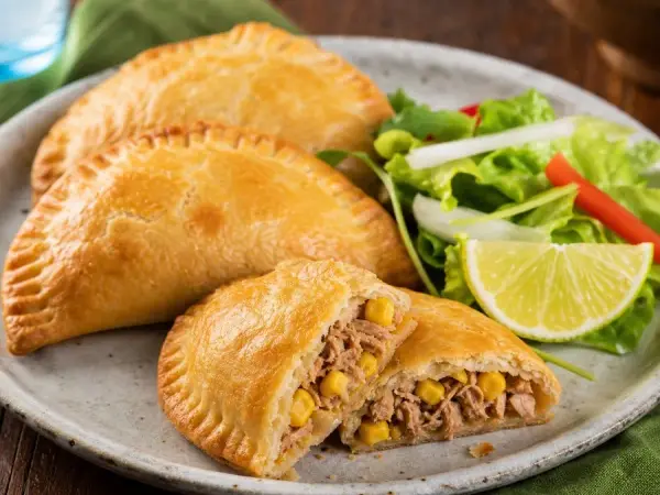 Cape Verdean Tuna Corn Hand Pies, plated as a finished dinner