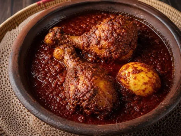 Ethiopian Doro Wat with hard-cooked eggs in a clay bowl