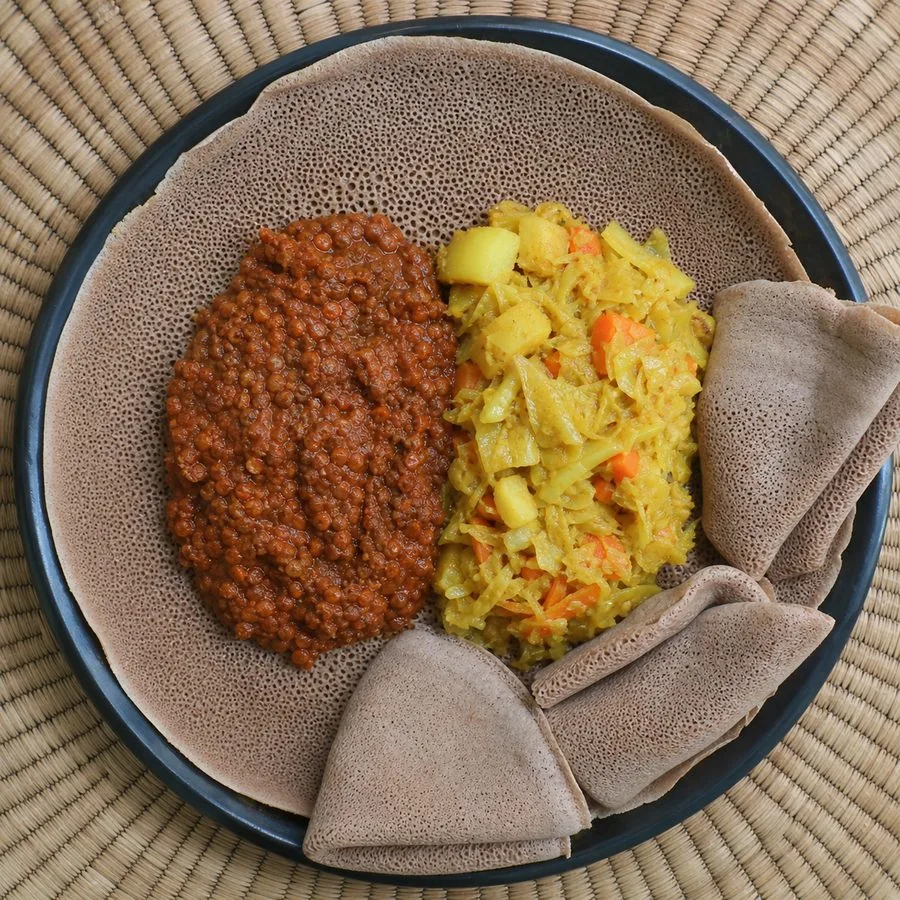 Ethiopian-inspired red lentil misir wot with braised cabbage, carrots, potatoes, and injera