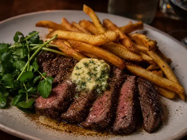Sliced steak frites with herb shallot butter