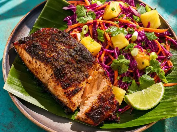 Jerk-crusted salmon fillet with pineapple, purple cabbage, and carrot slaw