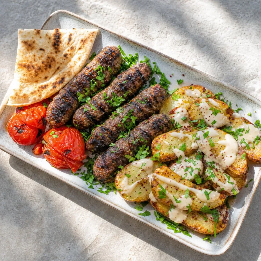 Lebanese Kafta with tahini potatoes, tomato, and pita