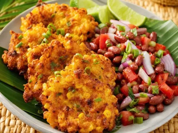 Malagasy Mofo Gasy Corn Fritters with Bean Salad, plated as a finished dinner