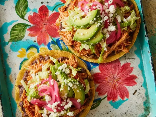 Crisp tostadas topped with chipotle chicken, avocado and pickled onions