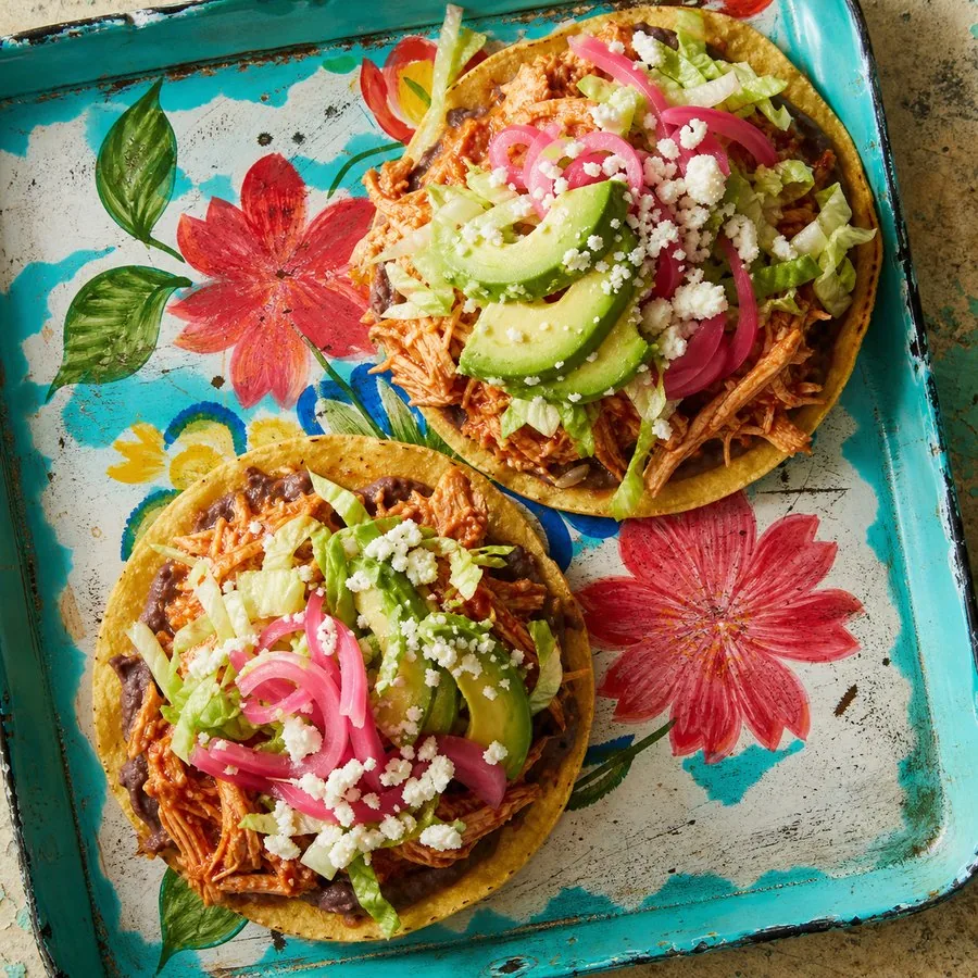 Crisp tostadas topped with chipotle chicken, avocado and pickled onions