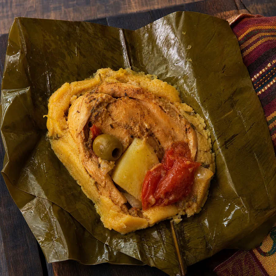 Banana-leaf wrapped chicken masa tamales with vegetables