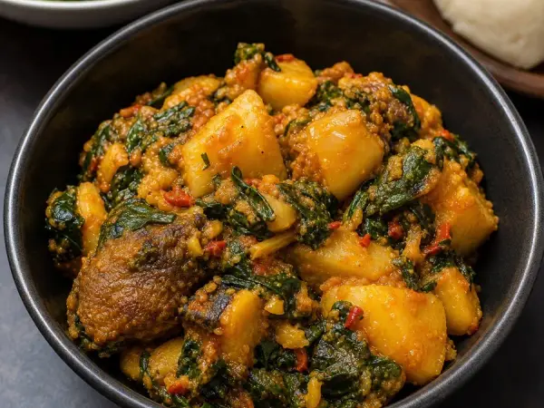 Nigerian Yam Porridge with Spinach, plated as a finished dinner