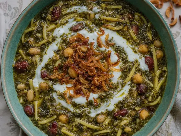 Persian Ash Reshteh with herbs, beans, noodles, and yogurt
