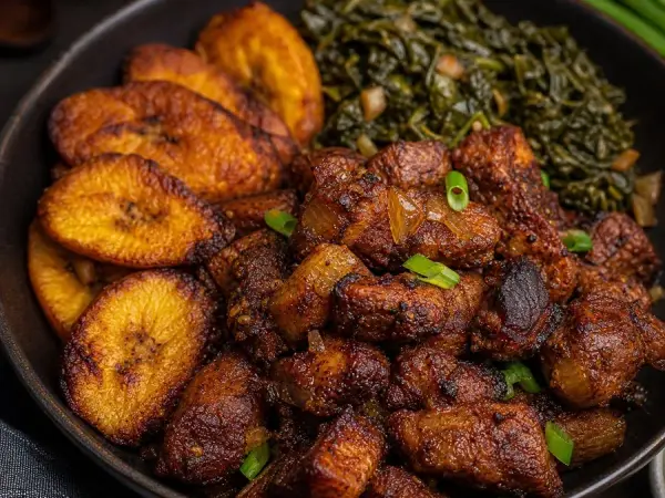 Rwandan Akabenz Pork Bites with Plantains, plated as a finished dinner