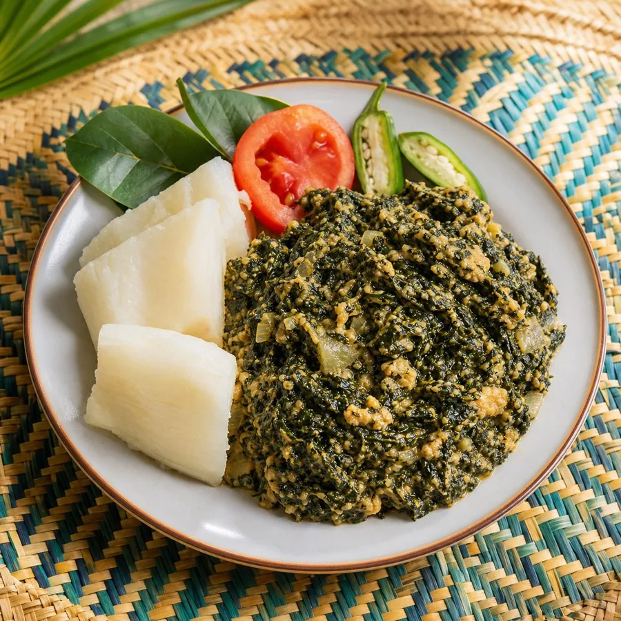 Rwandan Isombe Cassava Leaf and Peanut Stew, plated as a finished dinner