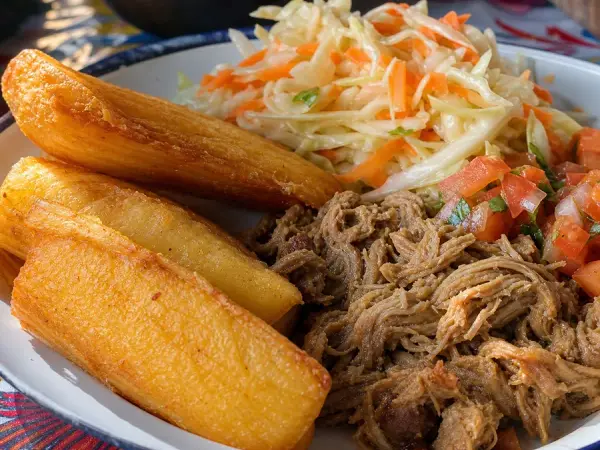 Crisp fried yuca with seasoned pork and cabbage curtido