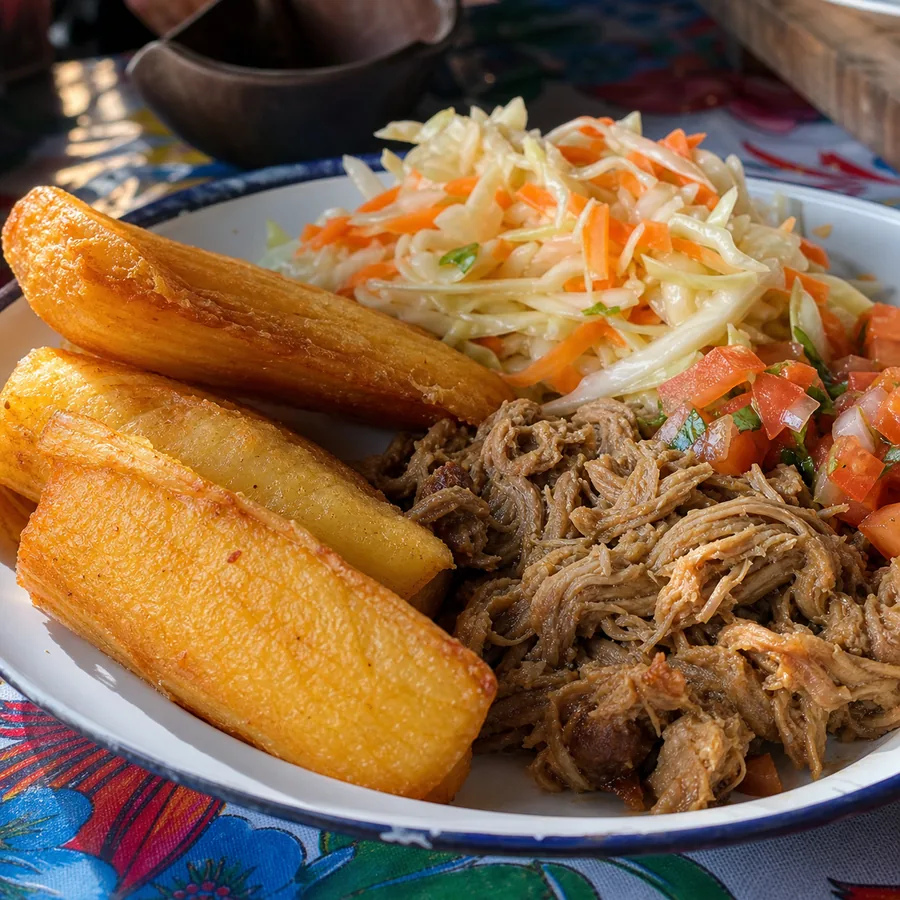 Crisp fried yuca with seasoned pork and cabbage curtido