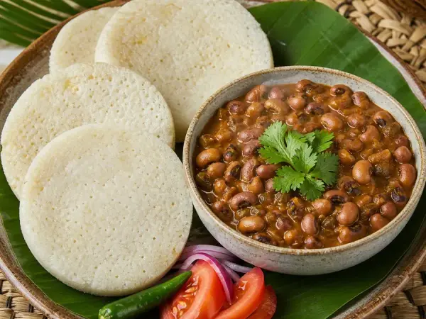 Togolese Ablo Coconut Rice Cakes with Bean Stew, plated as a finished dinner