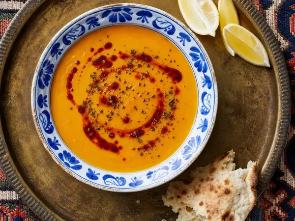 Turkish red lentil soup with Aleppo pepper oil, dried mint, lemon, and flatbread