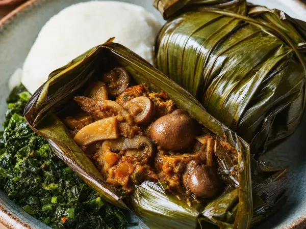 Ugandan Luwombo Mushroom Parcels, plated as a finished dinner