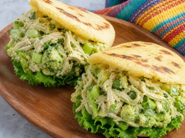 Golden corn arepas stuffed with avocado chicken salad