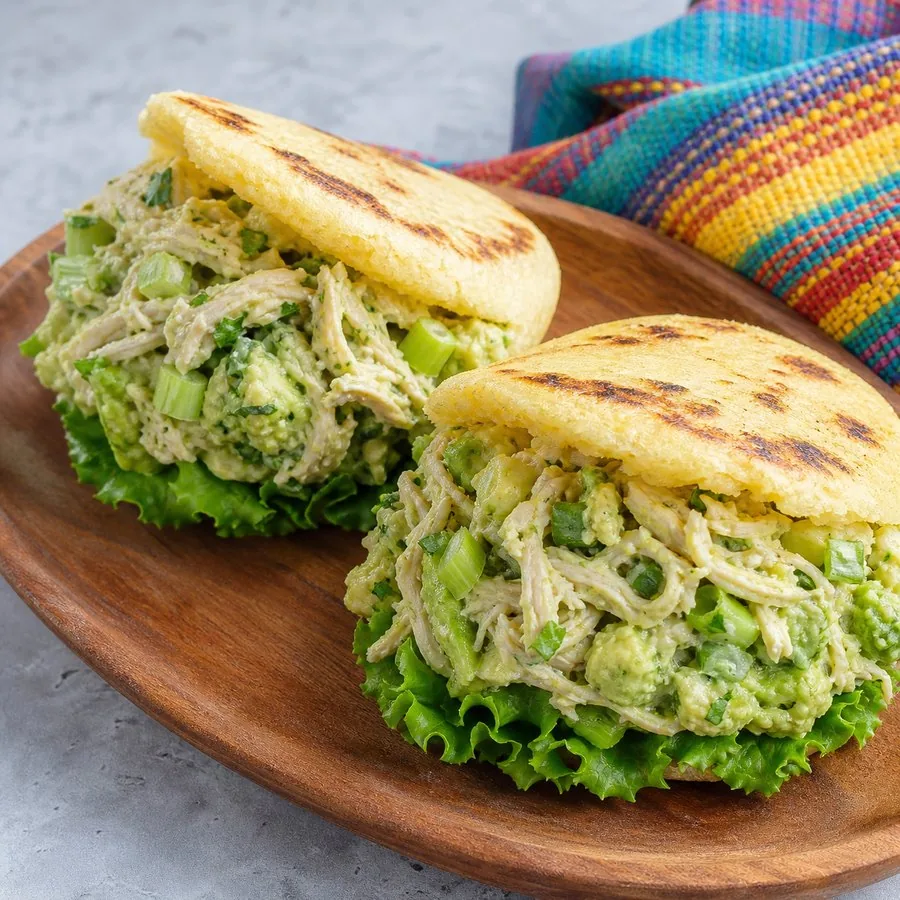 Golden corn arepas stuffed with avocado chicken salad